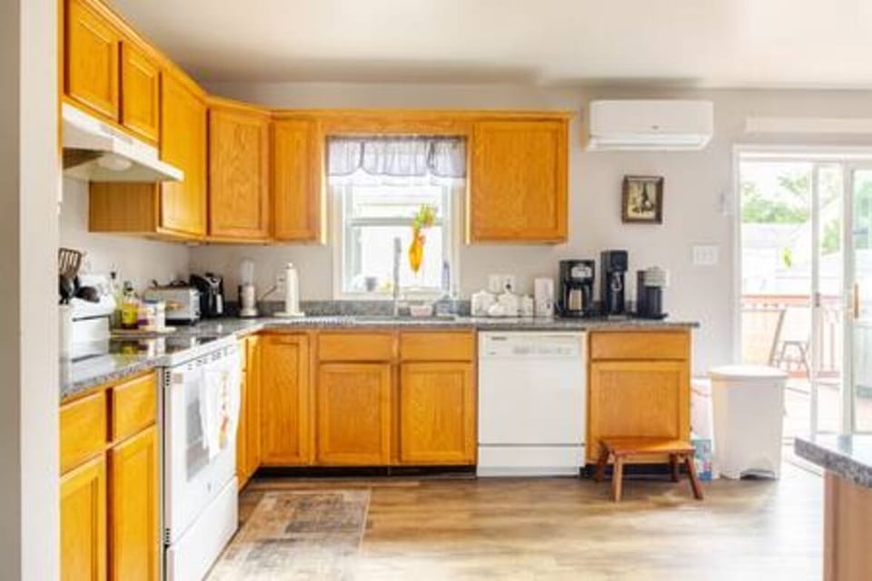 ✨ Bright full kitchen with stove, oven, dishwasher, and coffee station — perfect for family meals and easy access to the outdoor deck!