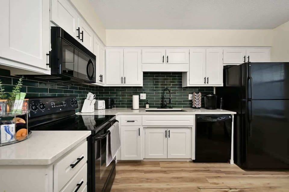 Fully equipped modern kitchen with updated appliances, quartz countertops, and everything needed for cooking during your Kansas City visit.