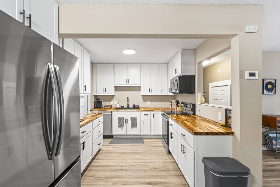 Kitchen | Sleek White Cabinets, Butcher Block Counters & Stainless Steel Appliances