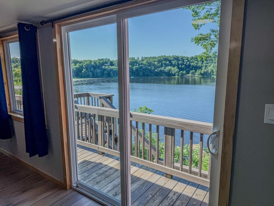 Private deck with stunning lake views through bright sliding glass doors