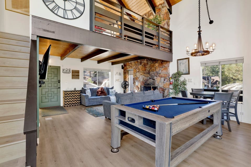 Open living room with pool table, dining area
