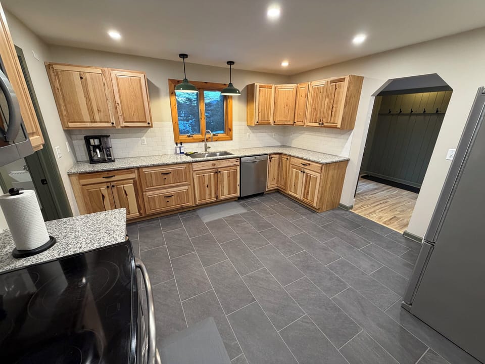 Full kitchen with fridge, dishwasher, coffee maker, toaster, microwave.