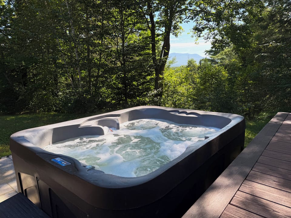 Hot tub with mountain views.
