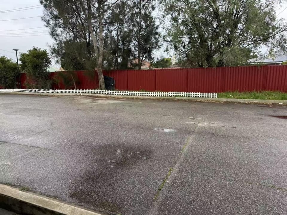 View out from the villa — yard and parking area. 