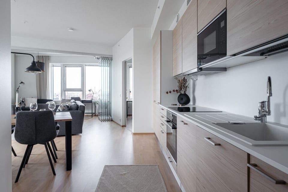 The fully equipped open kitchen has everything you need to prepare your favorite meals: a dishwasher, stove, oven, microwave, coffee maker, kettle, and a full set of cookware, dishes, and utensils.
