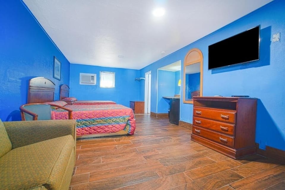 Stretch out in a spacious room with TV and dresser.