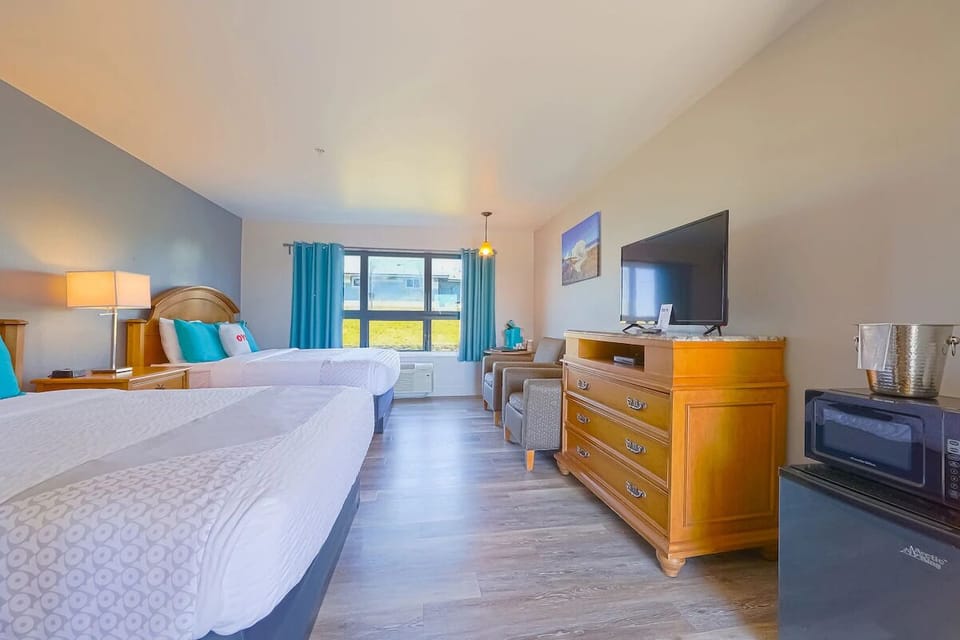 Unwind in airy comfort with two plush beds and sunlight.