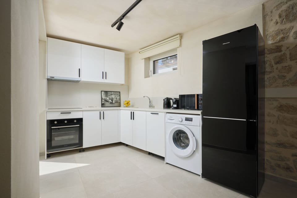 sleek european kitchen with modern appliances and a dedicated coffee station