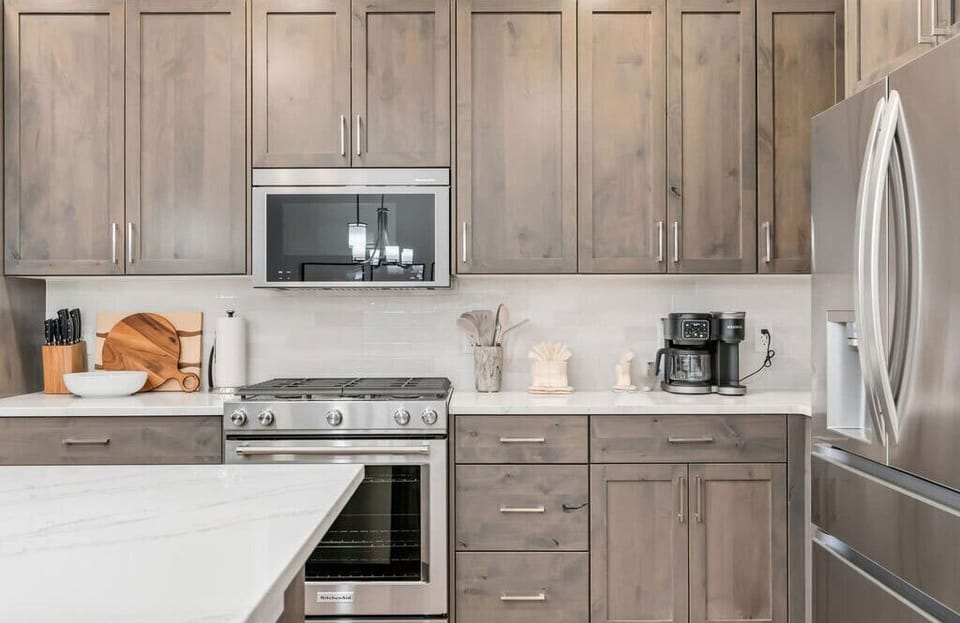 Your gourmet kitchen features sleek stainless steel appliances, spacious counters, and warm wood cabinetry for memorable meal preparations.