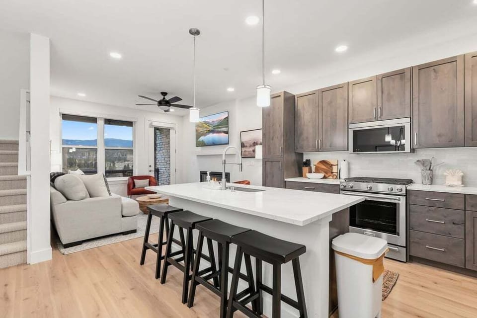 Cook your favorite meals in this sleek kitchen with granite counters, modern appliances, and gorgeous mountain views.