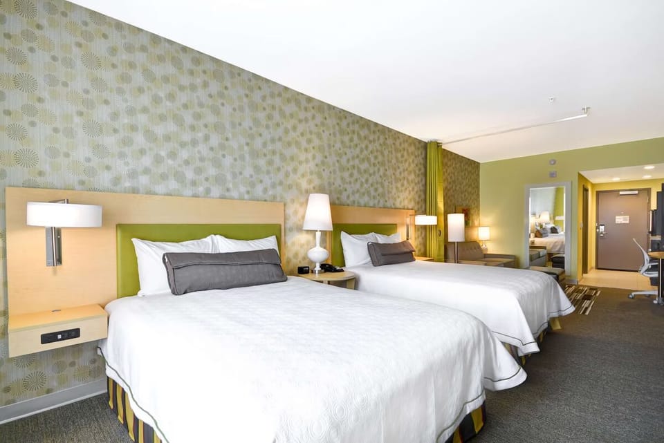 Sink into crisp linens beside warm, calming bedside glow.