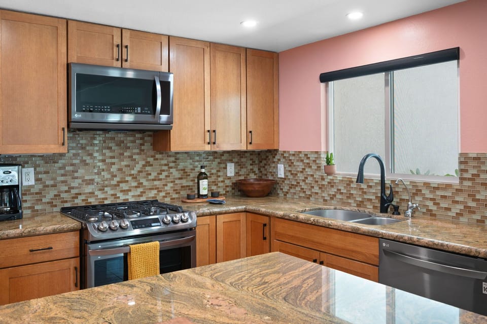Warm red-oak cabinetry and modern fixtures—style meets function.