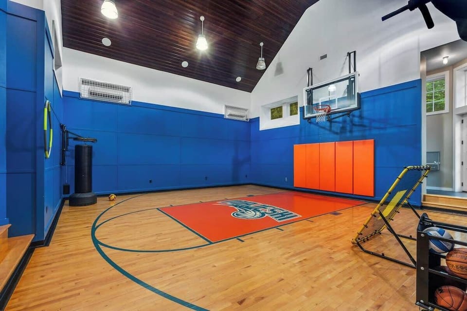 A private indoor half basketball court designed for all-season play. Shoot hoops, run drills, or let the kids burn energy while the rest of the house stays quiet. A rare, standout feature built for real fun.