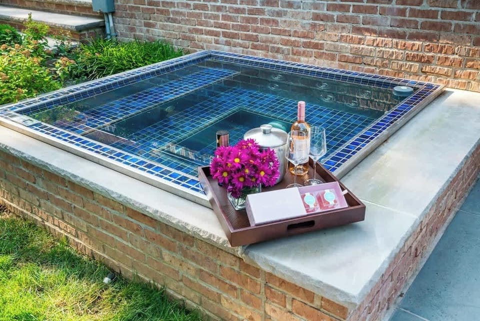 An intimate hot tub retreat, perfect for unwinding after a full day. Sip wine, relax under the open sky, and enjoy a quiet moment tucked into the landscaped backyard.
