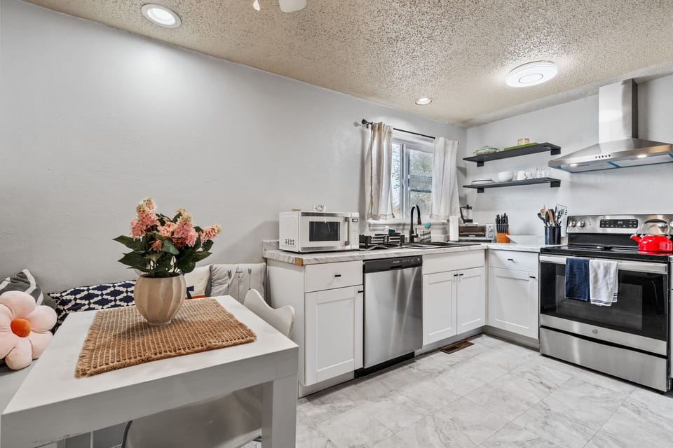 Step into your fully equipped kitchen where culinary adventures await! Bright white cabinets, sleek stainless steel appliances, and modern touches create the perfect space for preparing meals during your stay.