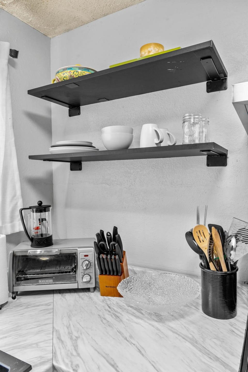 Cook your favorite meals in this well-equipped kitchen featuring modern appliances, ample counter space, and thoughtful storage. Everything you need is right at your fingertips.