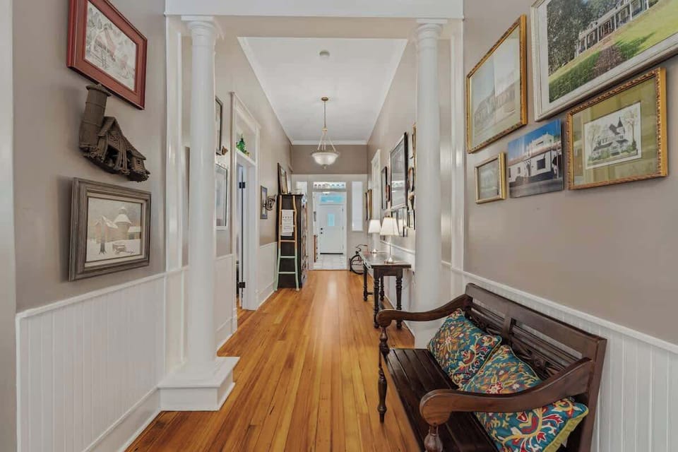 Art-Filled Hallway with New Orleans Charm.  Every step offers a visual story—reminiscent of a stroll through the colorful streets of New Orleans. It’s not just a hallway—it’s a journey through style, culture, and charm.