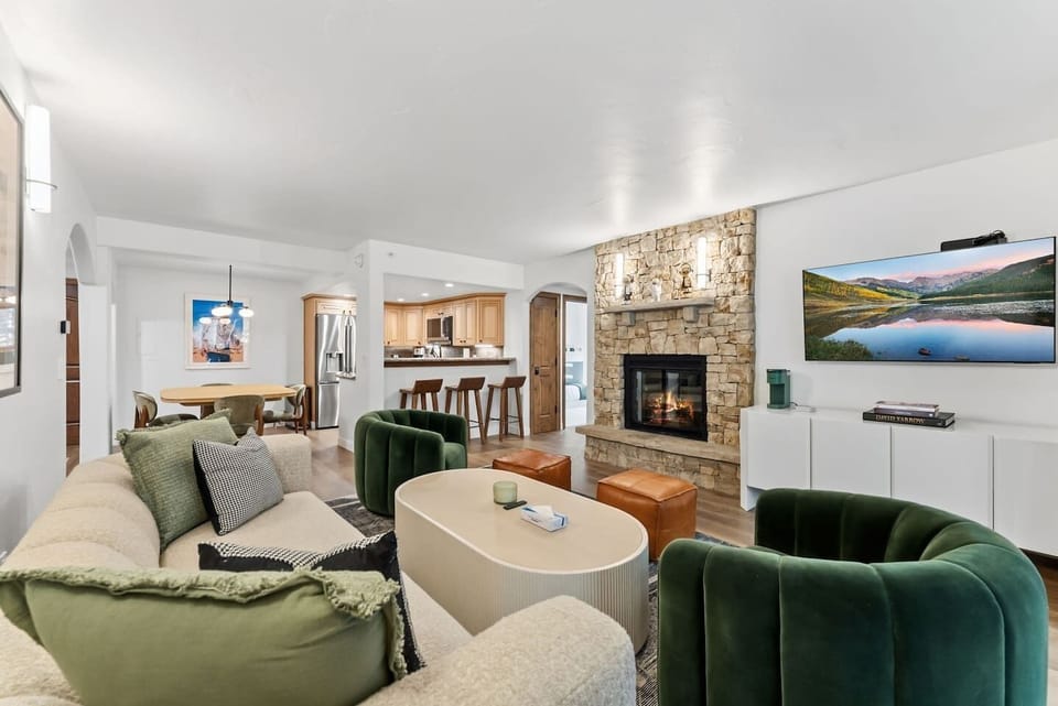 Newly renovated living room with fireplace, smart TV, and walkout balcony w/views