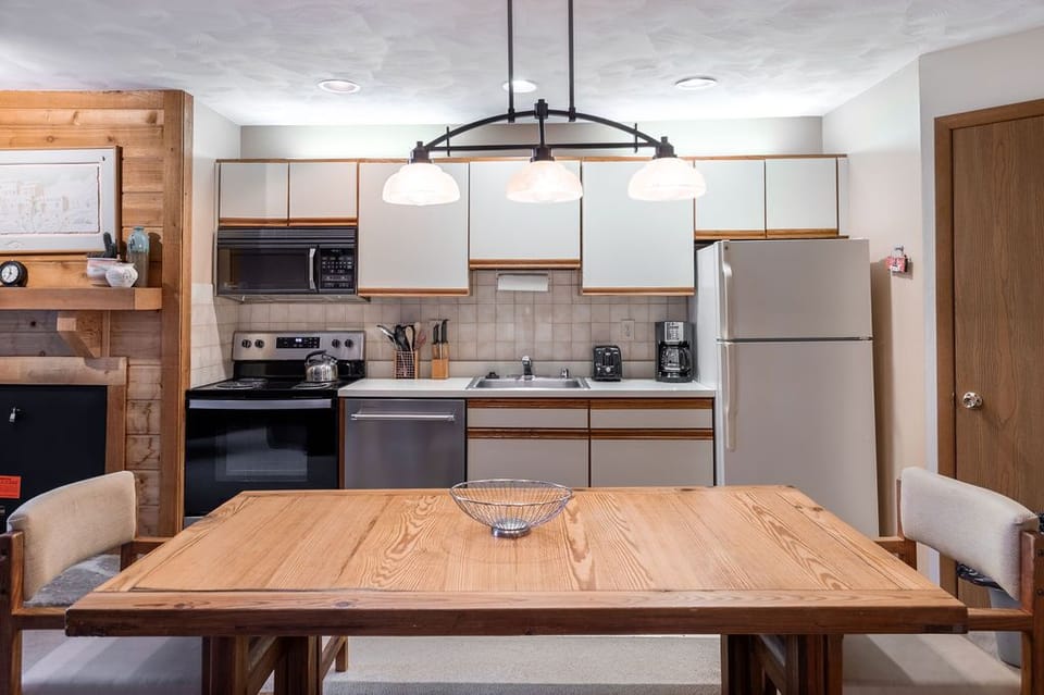 Open dining and kitchen space where mountain mornings begin with coffee and end with laughter around the table.