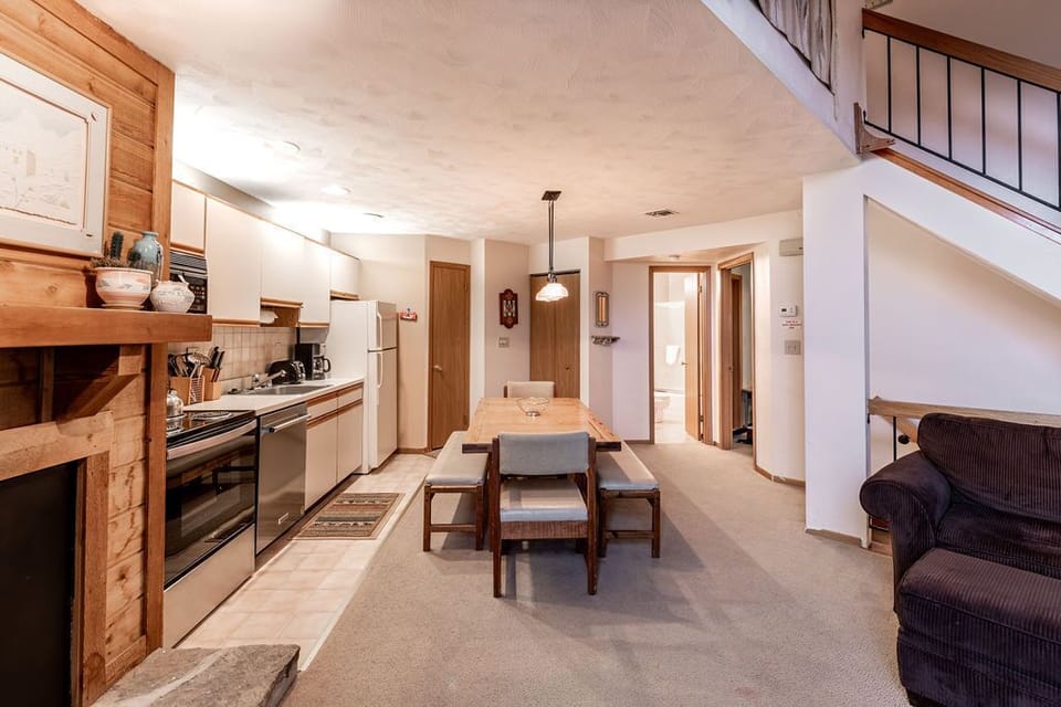 Welcoming open-concept living space anchored by natural textures and a gentle alpine glow, ideal for relaxing after a day outdoors.