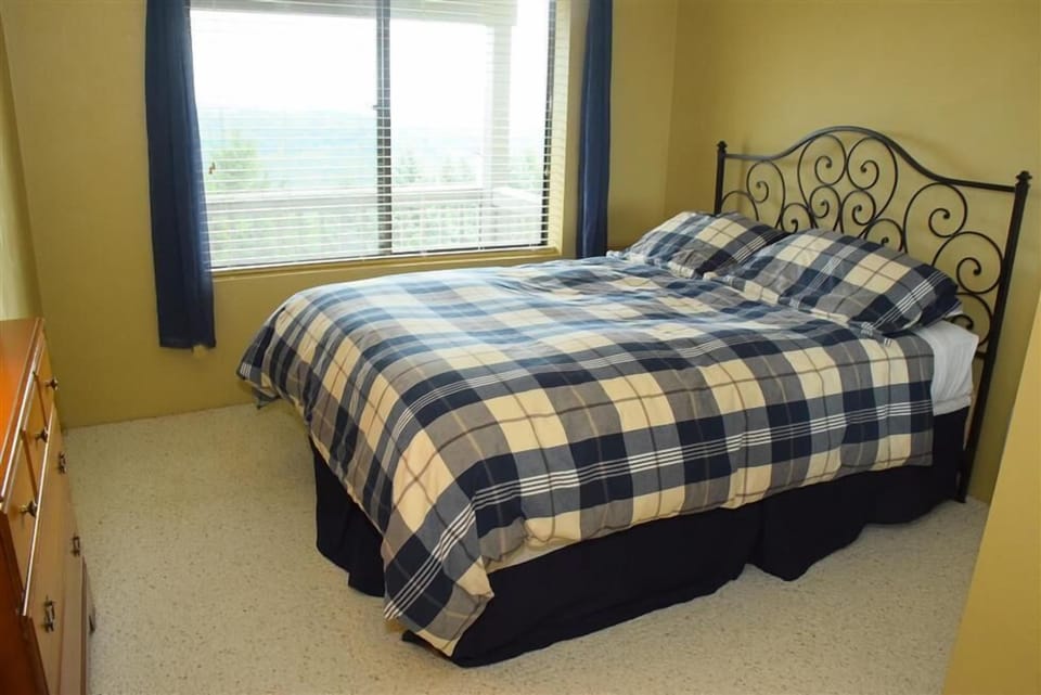 Peaceful guest room filled with gentle natural light and quiet comfort, offering restful sleep and serene morning views.