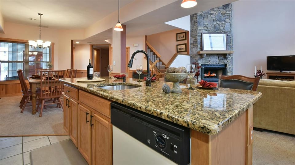 Golden tones and natural textures create a warm, welcoming kitchen where conversations flow as easily as the mountain air.