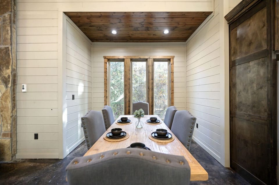 Large windows in the dining nook bring the outdoors into every meal.