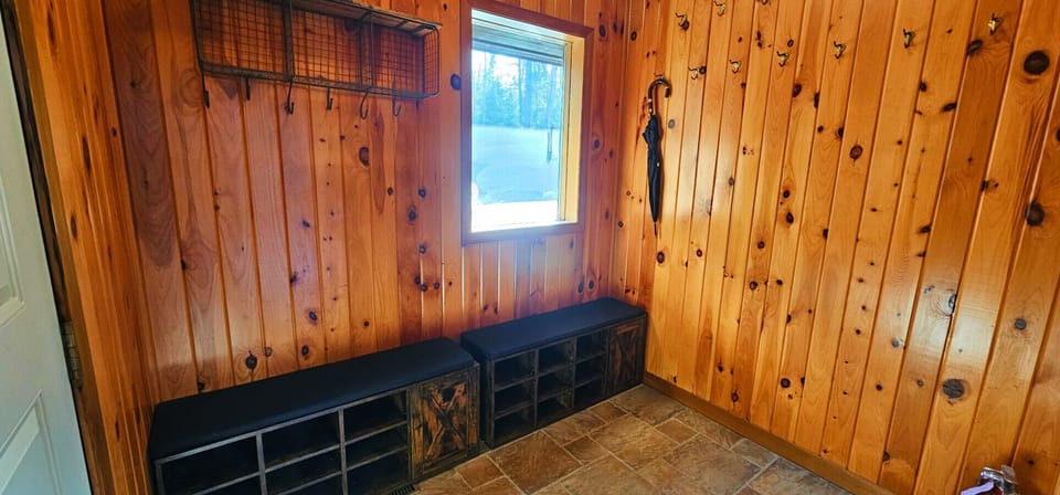 Rustic mudroom with built-in storage, bench seating, and convenient space for outdoor gear after a day of adventure.