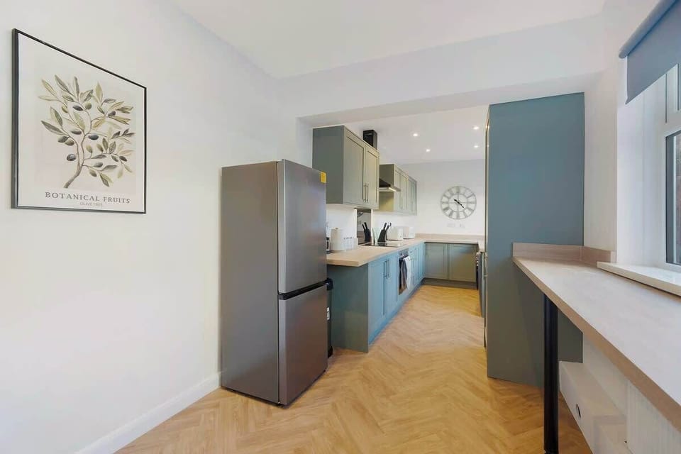 Kitchen equipped with all essentials, including a dryer, oven, fridge and full cookware set.
