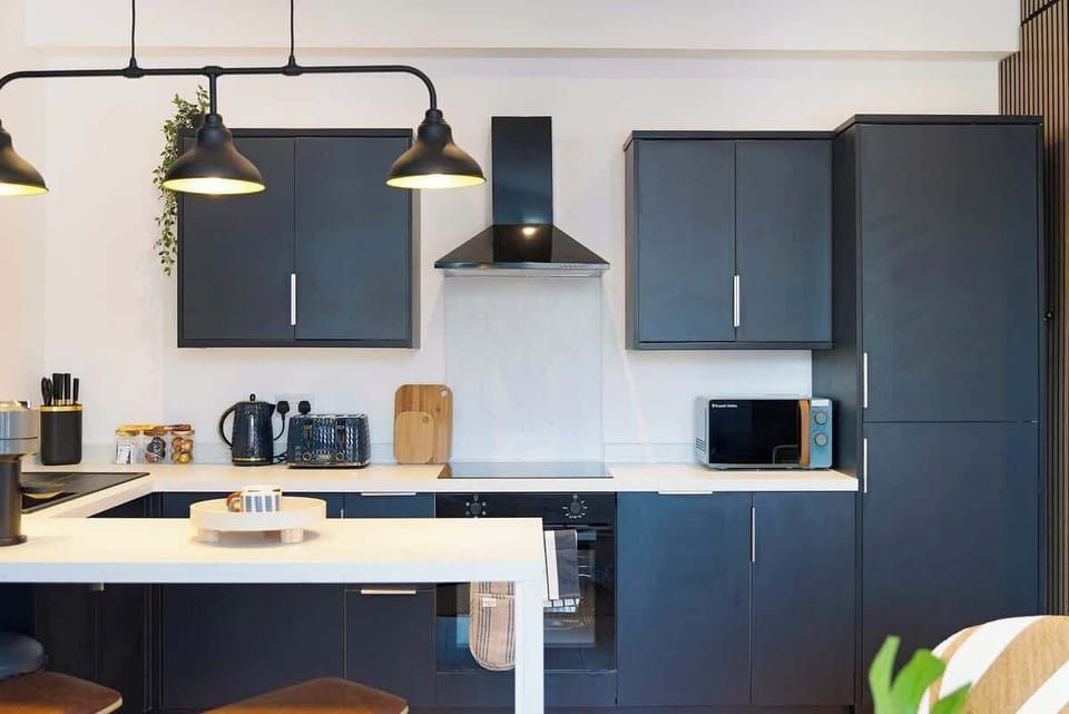 Kitchen equipped with all essentials, including a washer & dryer, oven, fridge and full cookware set.