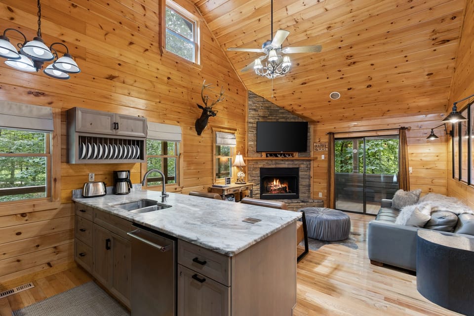 Open living/litchen layout with fireplace + TV