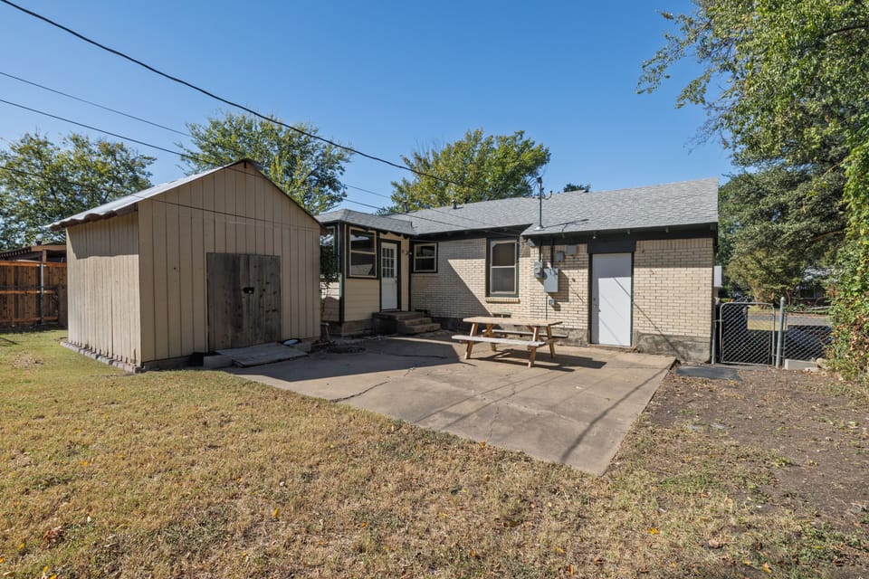 Enjoy a picnic table & open lawn in this spacious fenced backyard