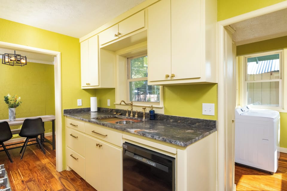 Bright, fully equipped kitchen w/ stainless steel appliances & warm wood floors