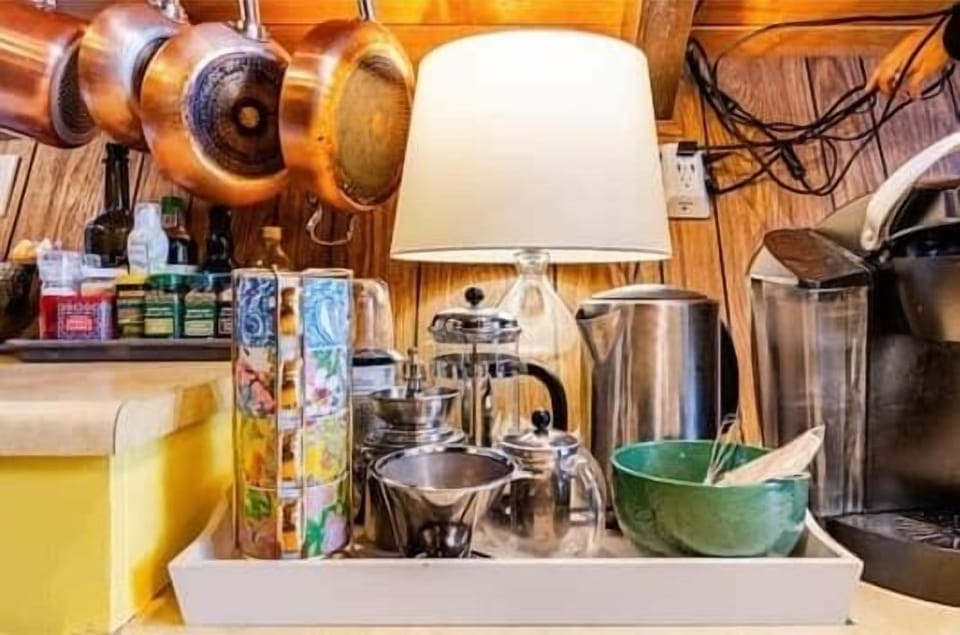 Coffee and tea station with bean grinders, French press, pour over, Keurig, and electric kettle.