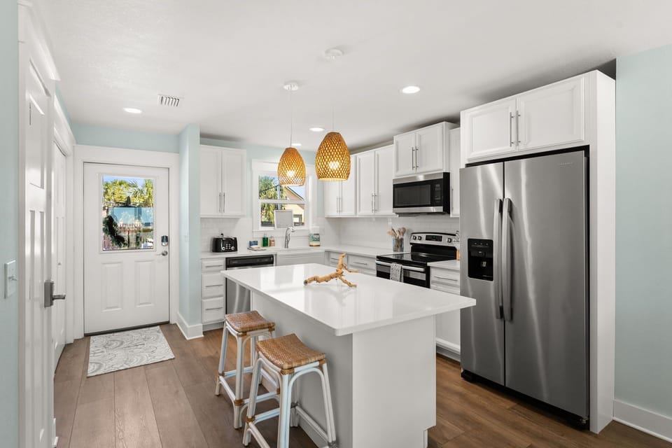 The gourmet kitchen isn't just beautiful—it's an invitation. Run your hands along cool granite countertops as you brew that first perfect cup.