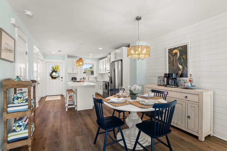 The dining table for four becomes the heart of your vacation, where sandy feet swing beneath chairs and stories spill out over leisurely breakfasts that stretch into afternoon.