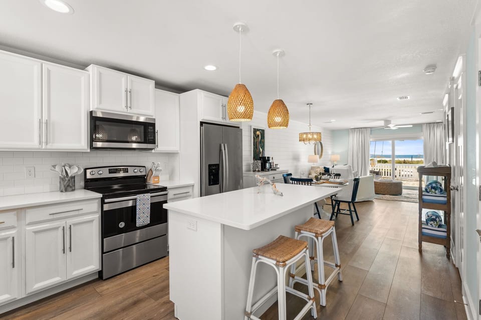 Everything you need is here: premium cookware that feels substantial in your hands, elegant plates and crystal glasses catching the light, a spacious island where your family gathers on the bar stools, laughing and stealing bites as you prepare a feast