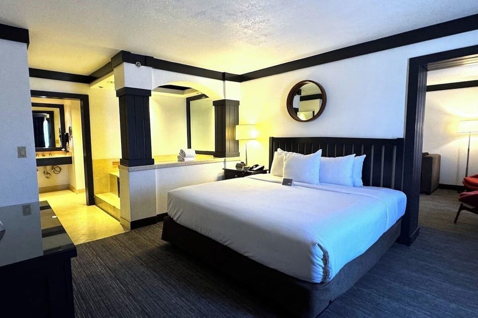 Recharge in a spacious king room with warm ambient lighting.