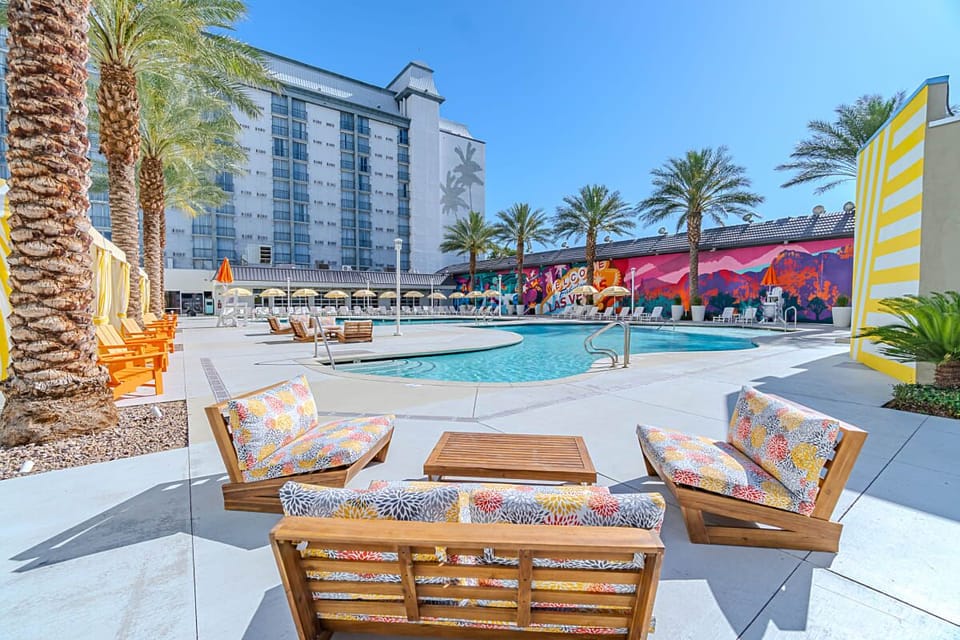 Unwind poolside with colorful loungers and endless blue skies.