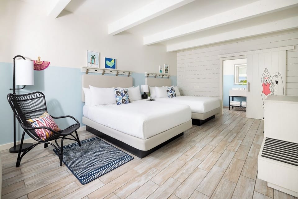 Unwind in airy comfort with two plush beds and beachy decor.