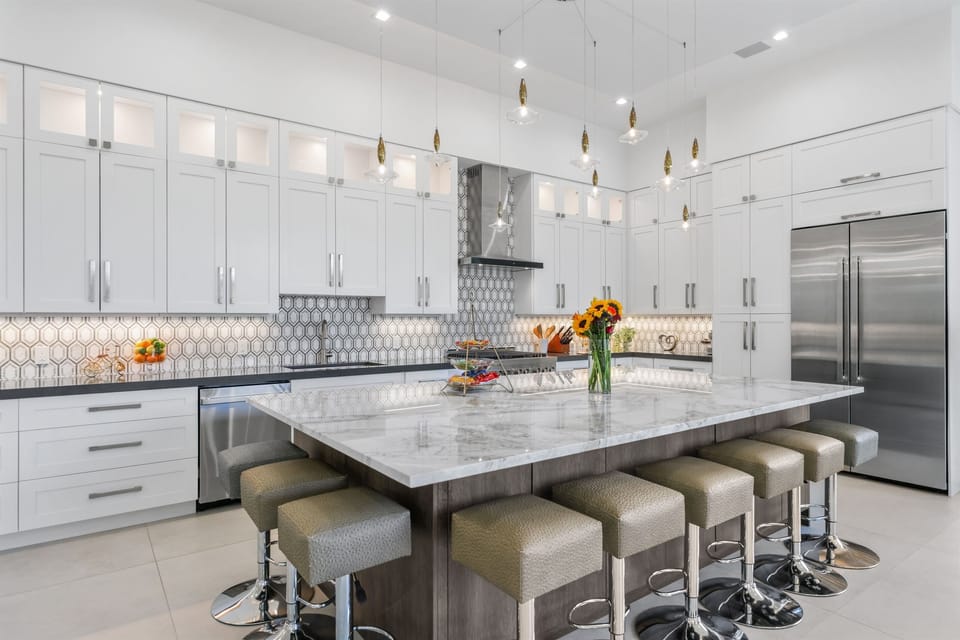 Massive porcelain island – seats eight for cocktails, breakfast, or casual gatherings.