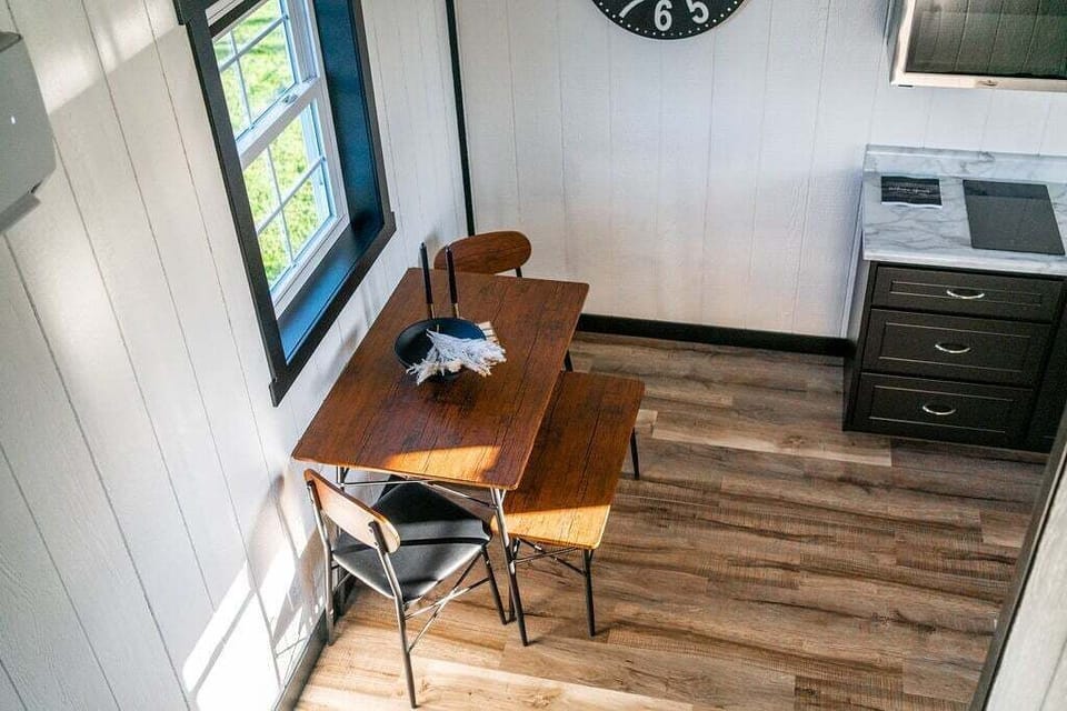 Dining area right next to the kitchen with two chairs and a bench