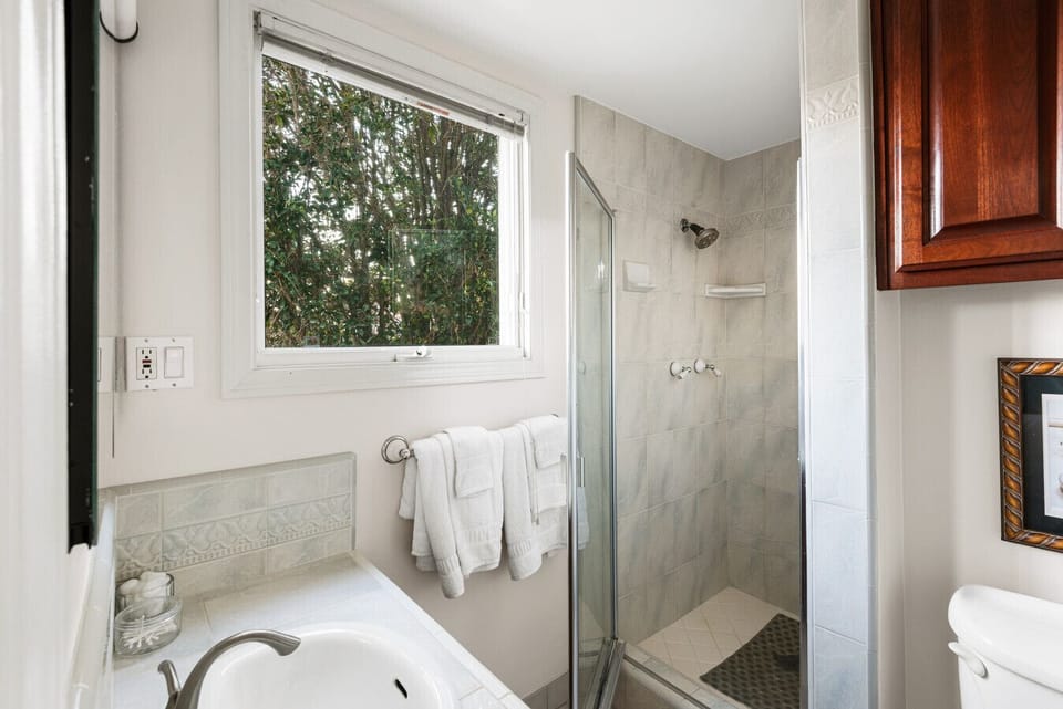 An immaculate bathroom offering a spacious walk-in shower and a fresh, modern feel.