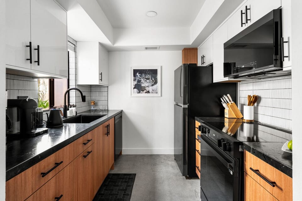 A sleek and fully equipped kitchen with modern appliances ready for home-cooked meals.