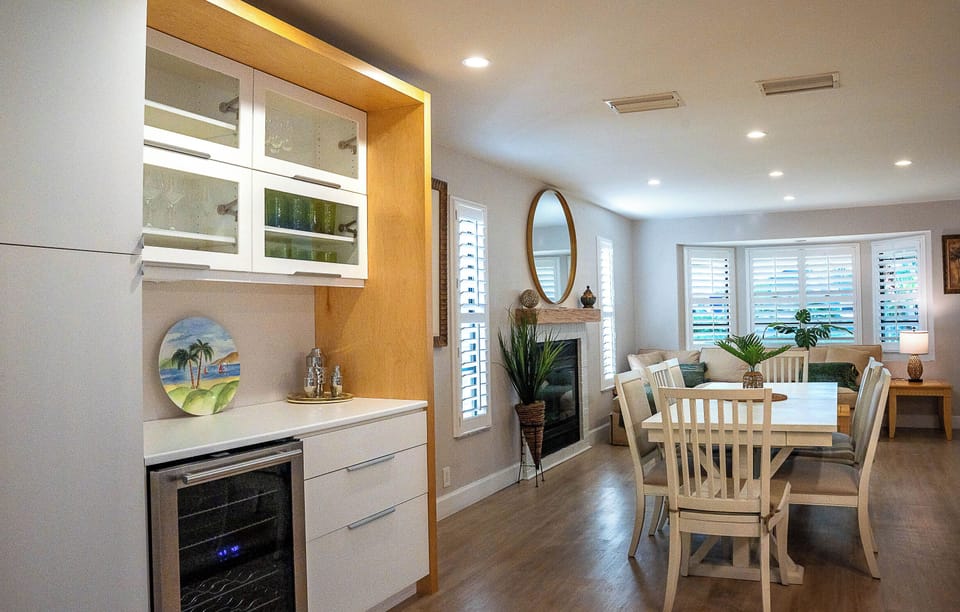 wine cooler and bar includes plates and glassware shakers for drinks