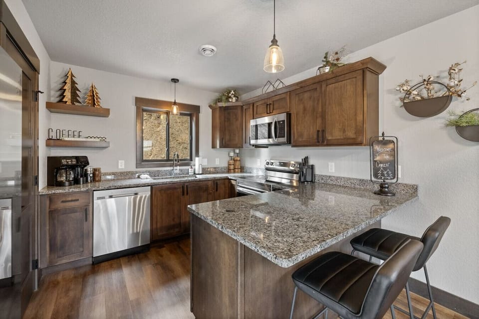Modern stainless steel appliances, including a dishwasher, microwave, and range, are provided for your convenience.