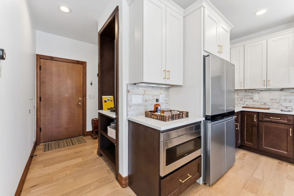 Kitchen [main floor]: Drip coffee maker, KitchenAid appliances, blender, kettle, cooking utensils, tableware