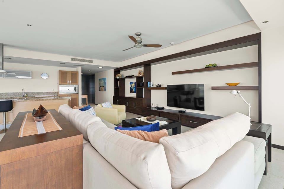 TV room with couch &  balcony view 