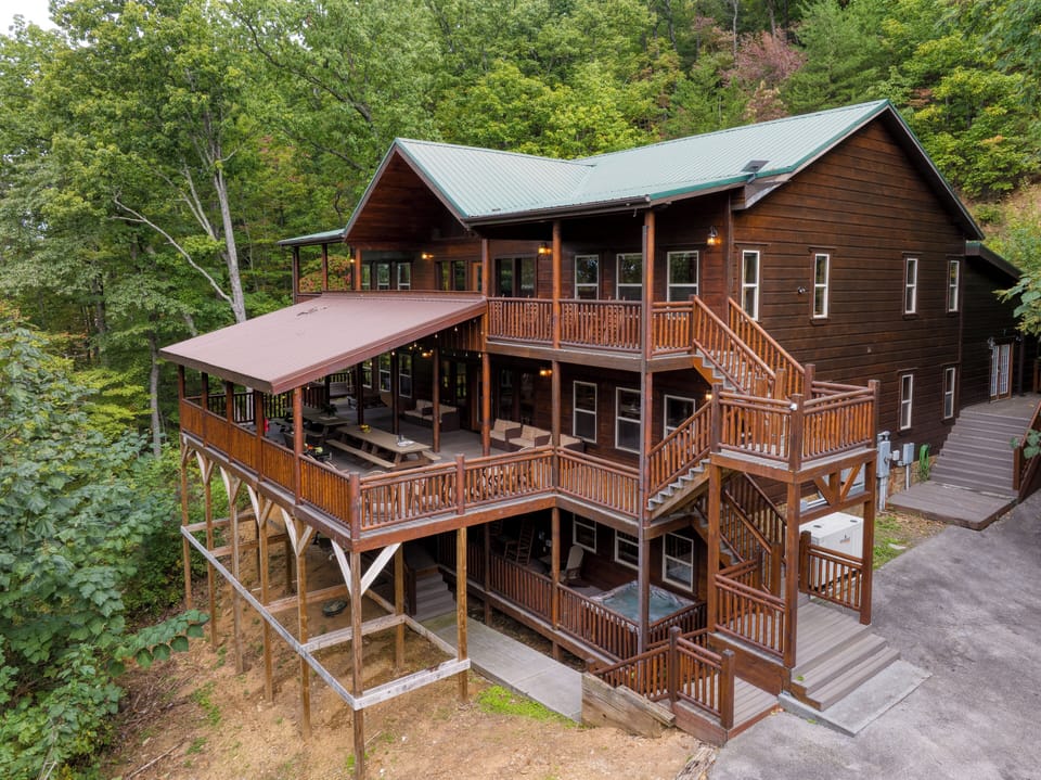 Your ultimate mountain escape awaits. This massive, multi-level cabin retreat offers endless decks, stunning views, and space for everyone to gather and relax.