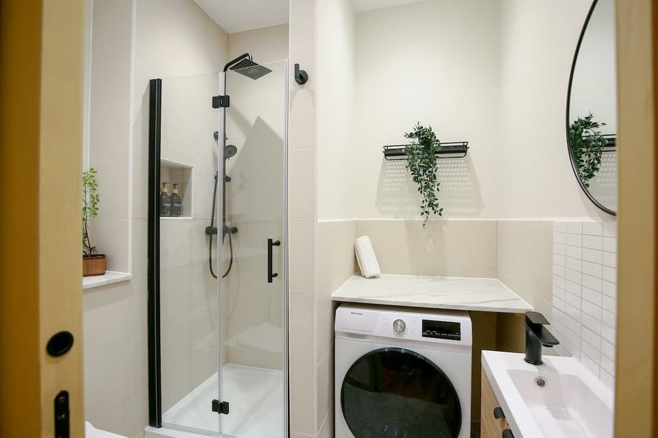 Full bathroom with washer and dryer